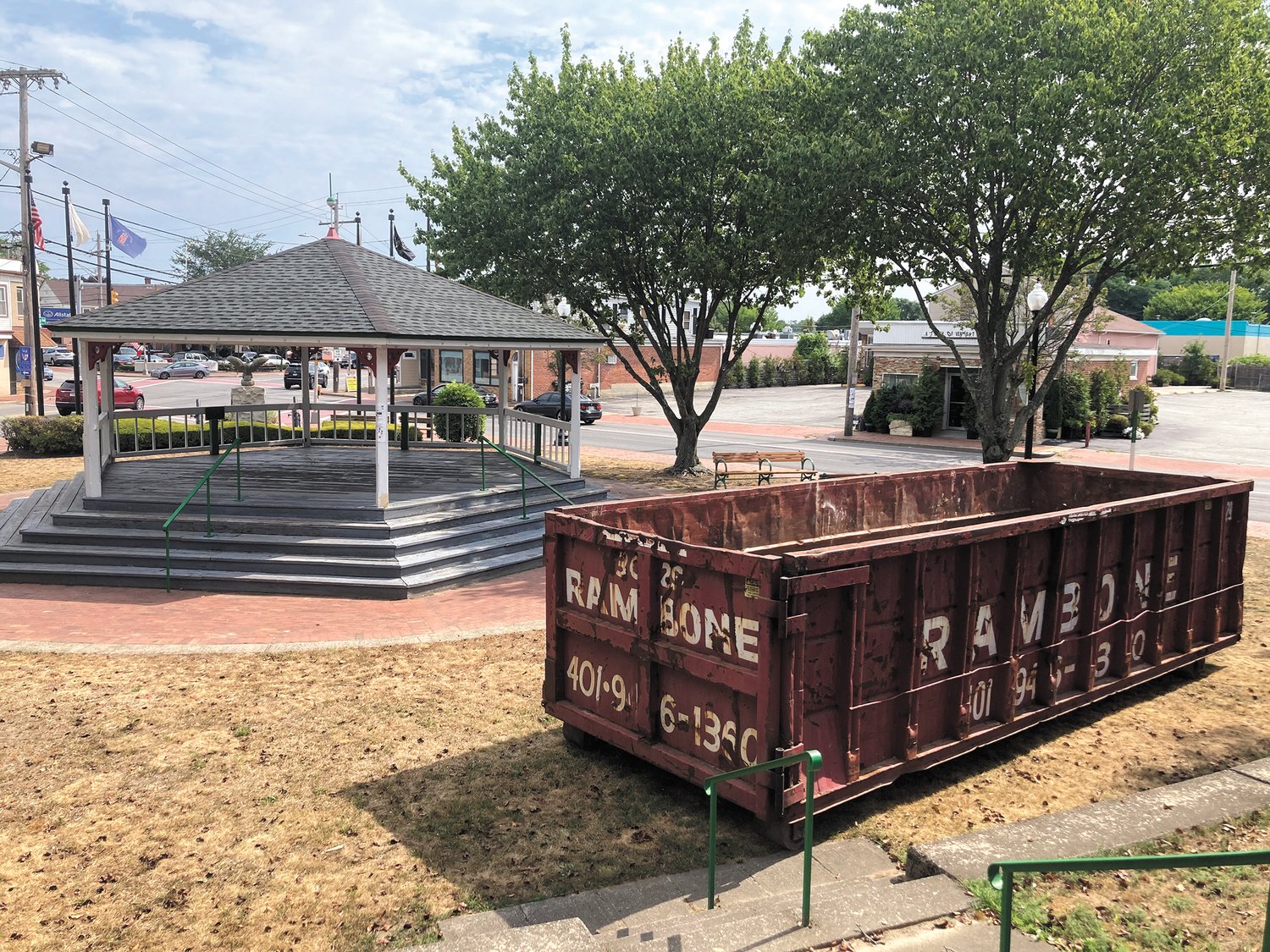 READY FOR IN-HOUSE WORK: A dumpster located by the Knightsville gazebo is getting ready for in-house site work for the Knightsville revitalization project. City workers will take down shrubs, trees and possibly level the hill. (Herald photo)